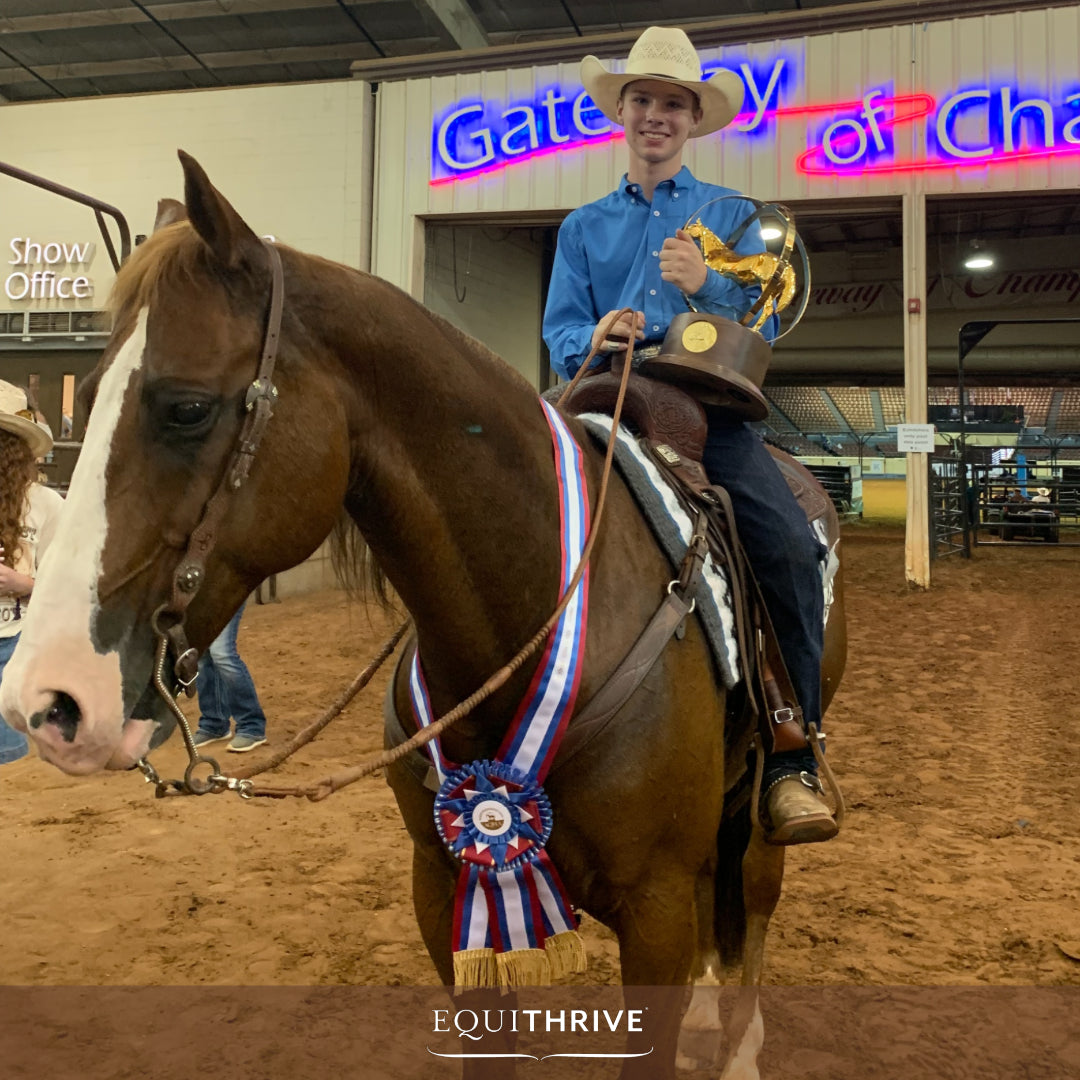 Young Bryce Barkemeyer in a cowboy hat holding a trophy while sitting on a decorated horse at a championship event.